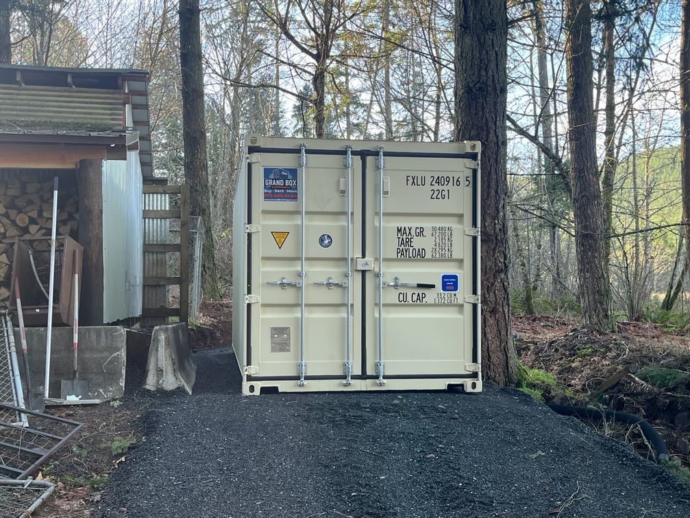Construction Storage Container Rental on a Gravel Pad in a Wooded Area - Grand Box Northwest