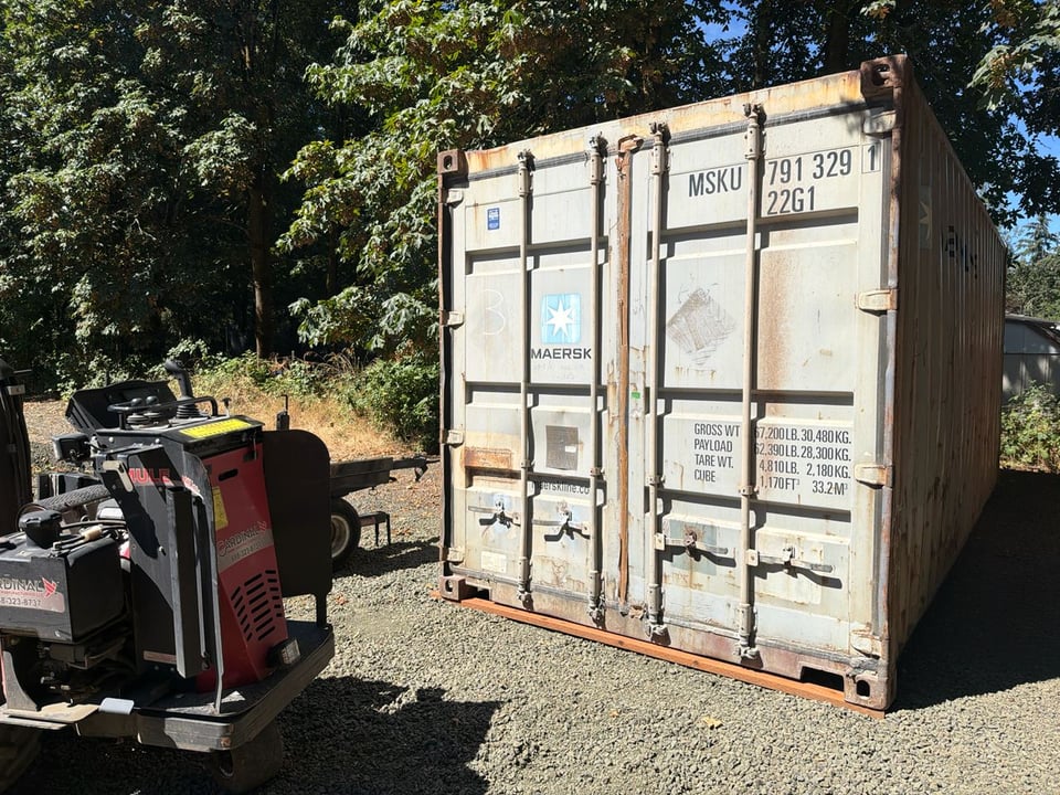 Construction Storage Container Rental Beside a Compact Forklift - Grand Box Northwest
